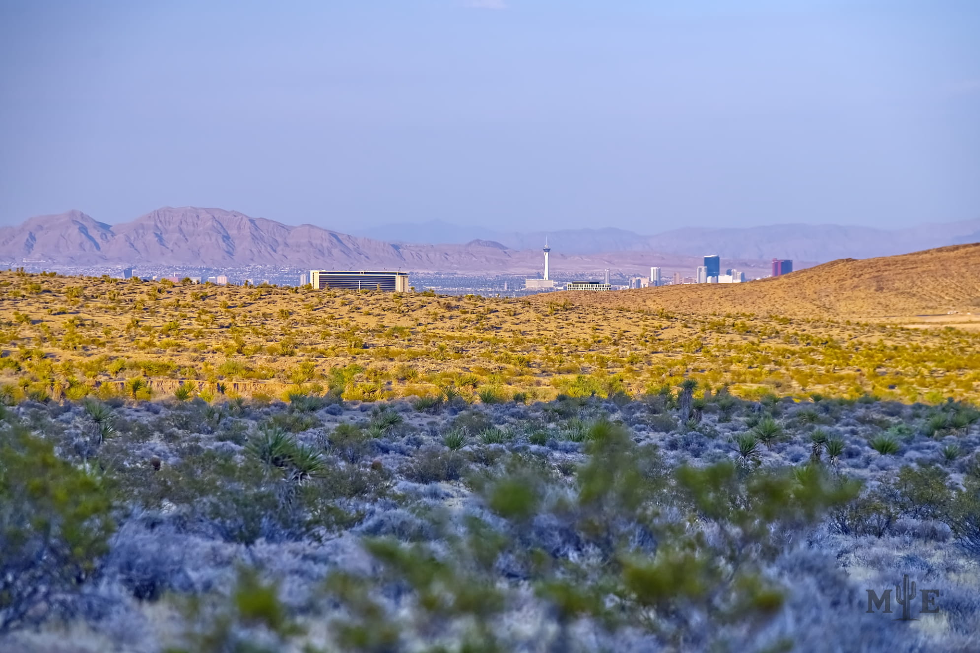 Less then half a dozen hotels peeking over a Mohave Desert terrain. Captured on the outskirts of Red Rock Canyon Las Vegas.