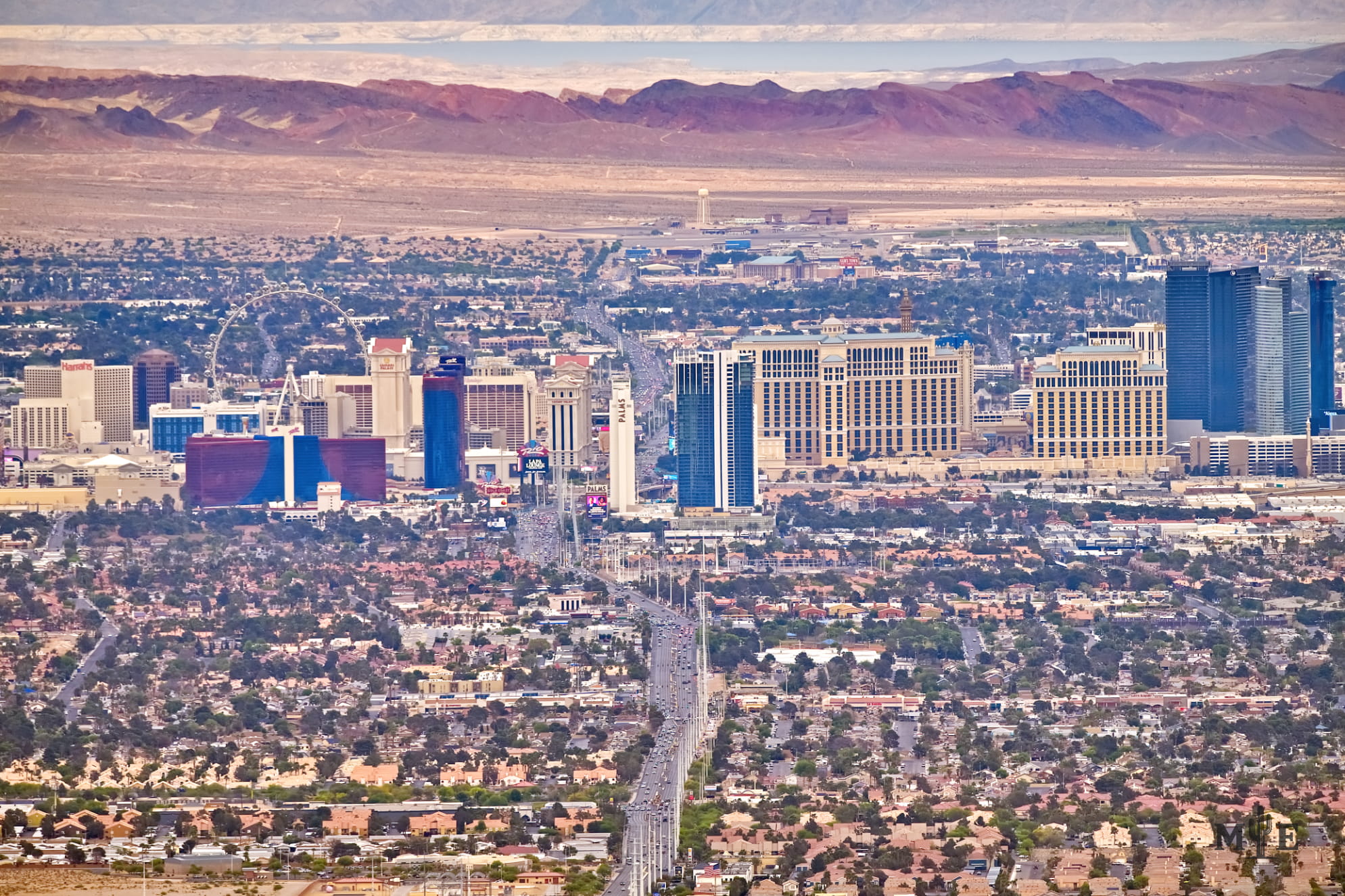 Wide view of about a dozen hotels on The Strip with Lake Mead in the background. Telephoto shot spans nearly two states.