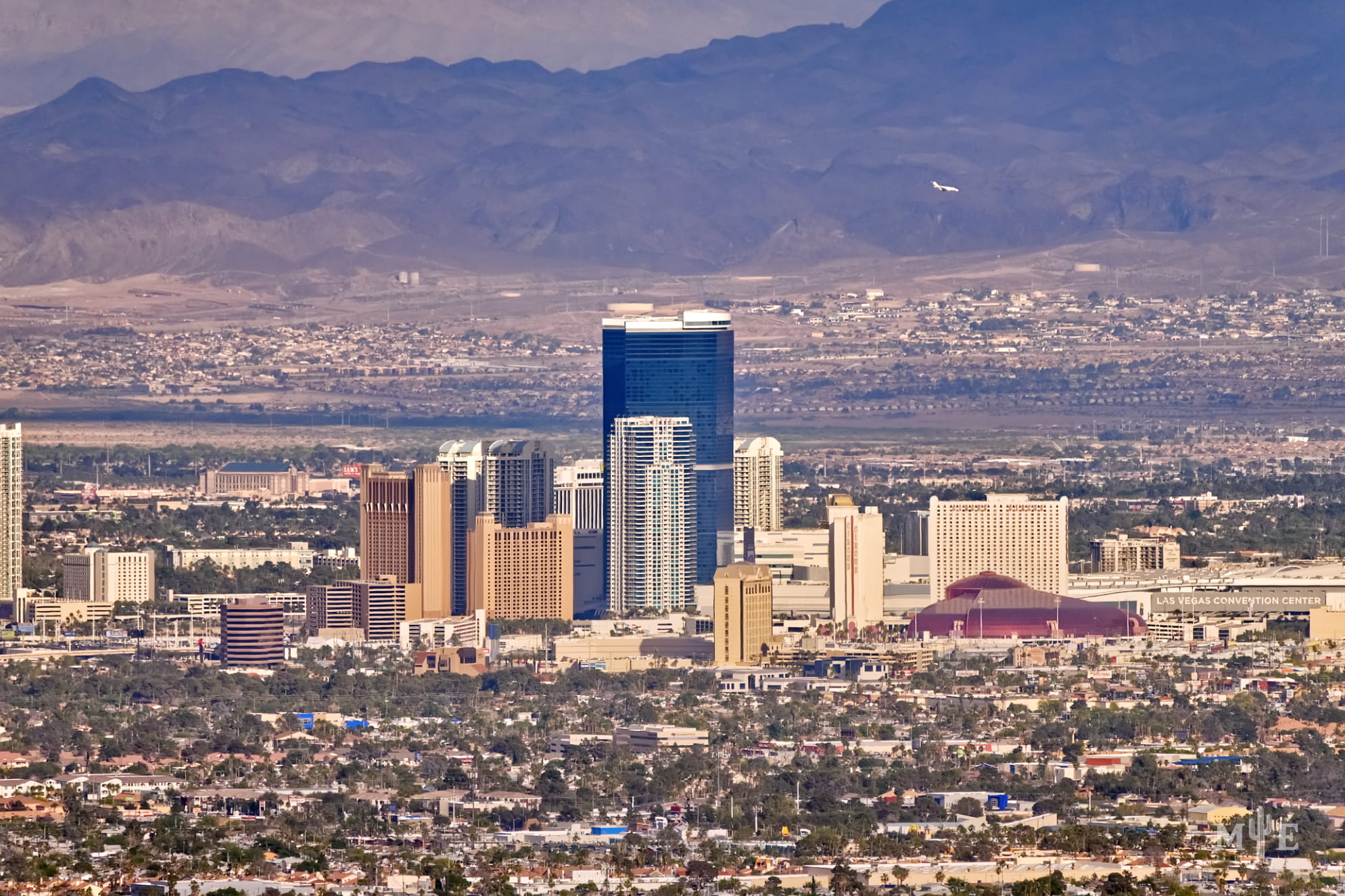Fontainbleu, Circus Circus, and a dense collection of other hotels centered among mountains and the metro area.