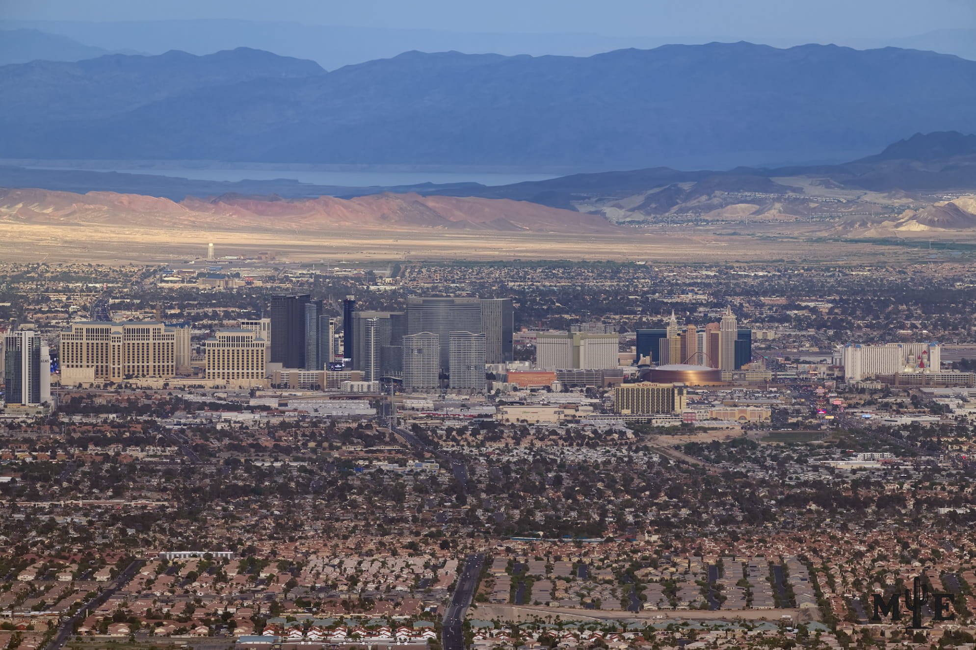 Wide view across the Las Vegas Valley toward the full resort corridor, with mountain ridges framing the metropolitan basin.