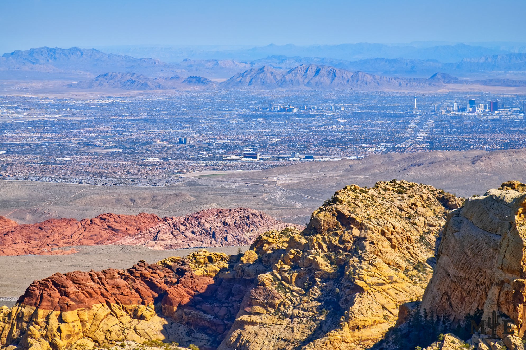 Layered sandstone ridges above the expansive Las Vegas Valley, showing the desert geography surrounding the City of Las Vegas.