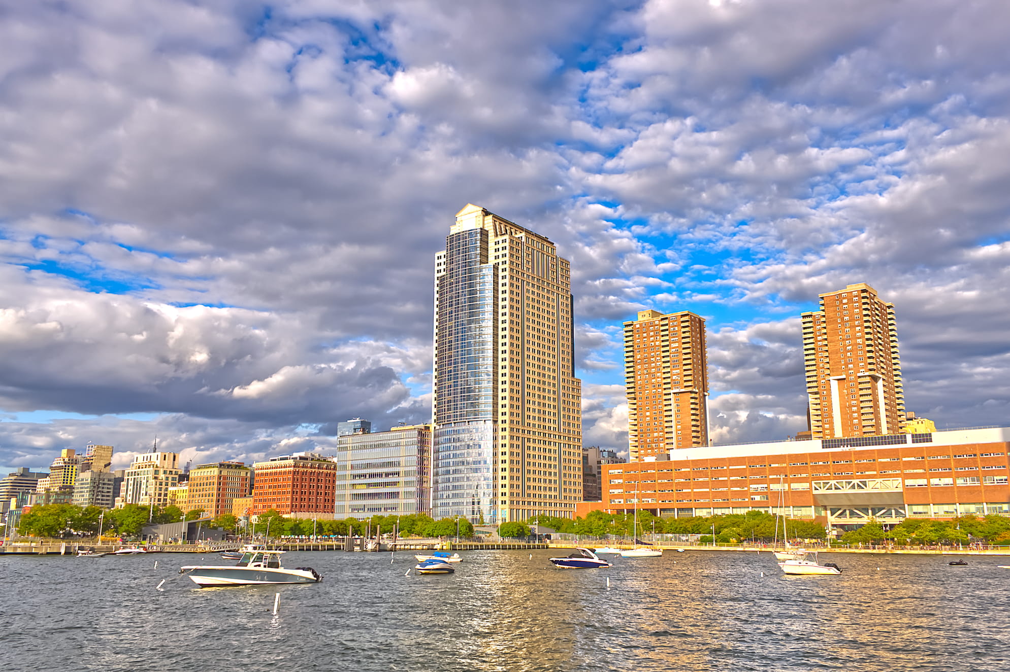 Dramatic clouds over a small city skyline in New York City with water and boats out. Clouds adding tremendously to the scene.