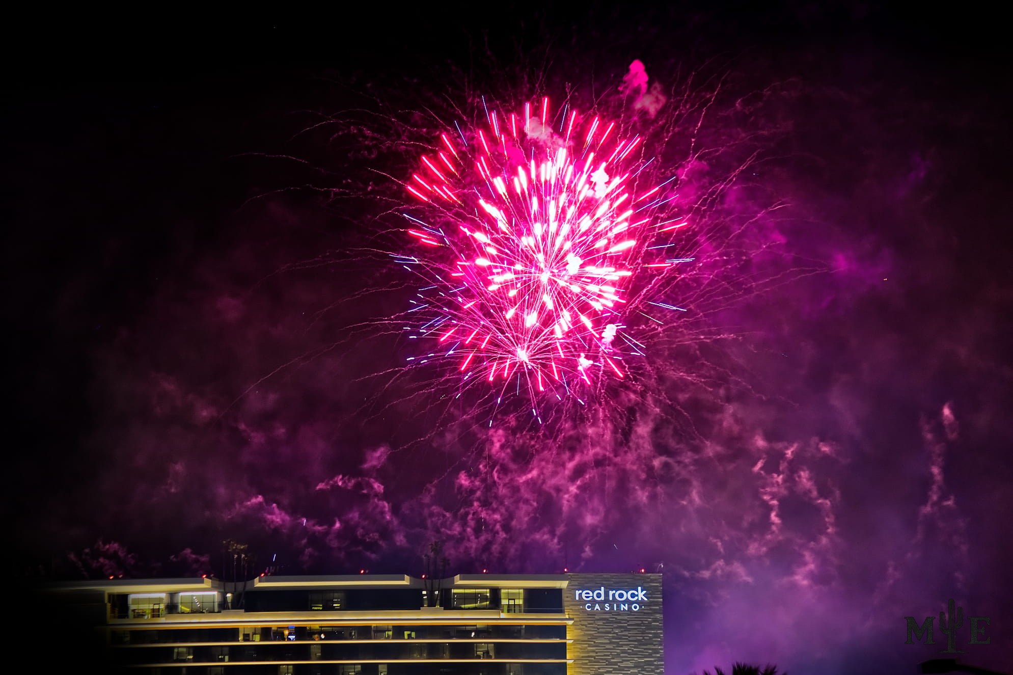 Pink fireworks burst through a haze of smoke above Red Rock Casino in Summerlin during a Las Vegas Valley celebration.