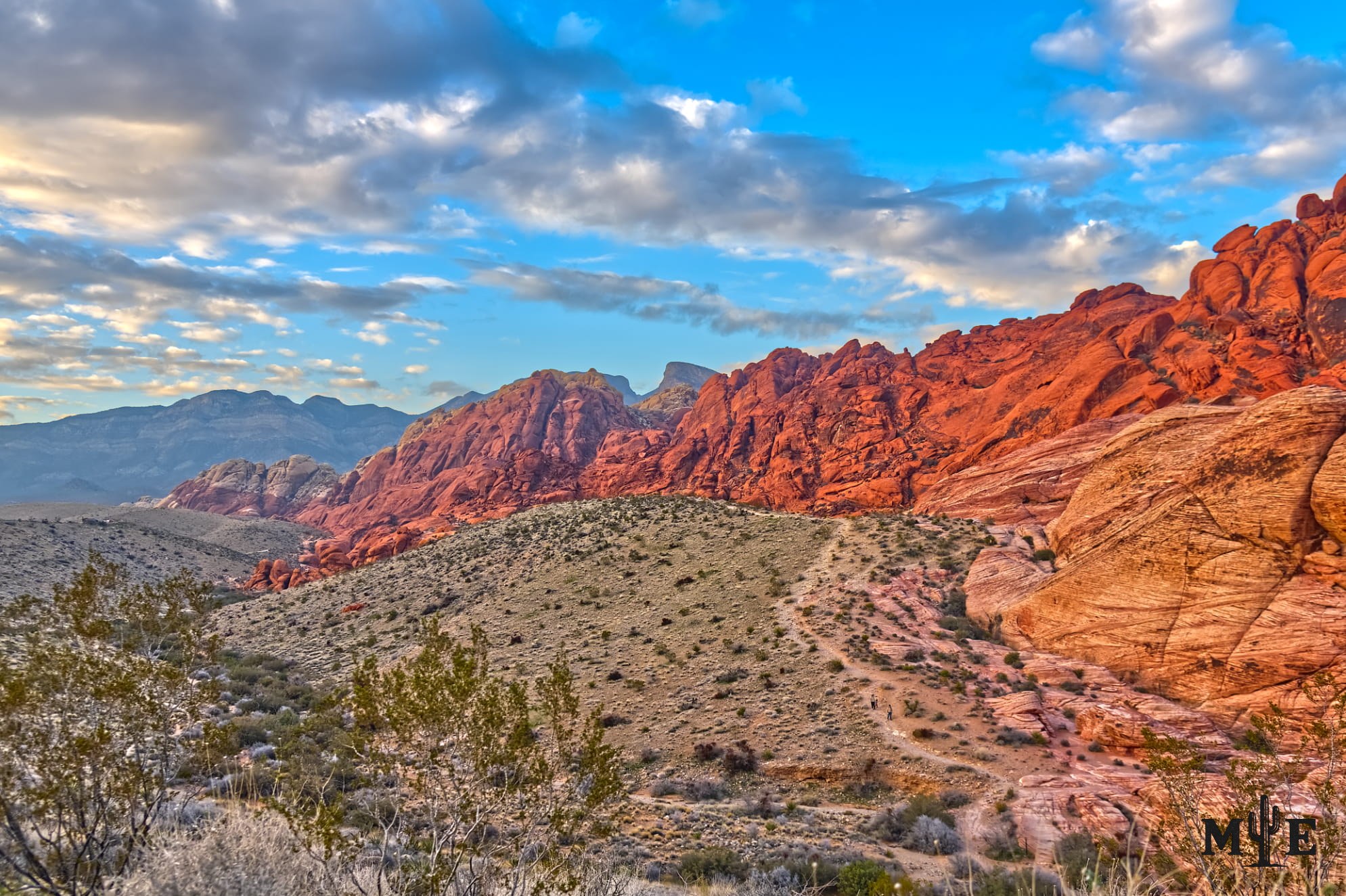 Picture perfect sky and clouds with vibrant red rock and golden sandstone. Desert environment.